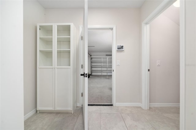 hall with light tile patterned floors