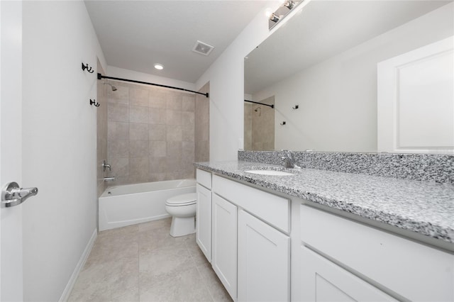 full bathroom featuring toilet, vanity, tile patterned flooring, and tiled shower / bath combo