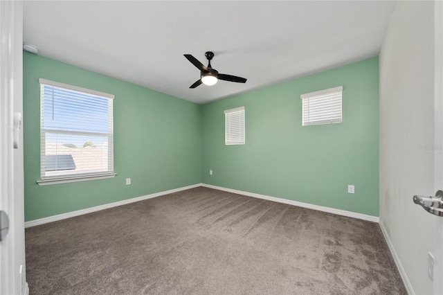 carpeted spare room featuring ceiling fan