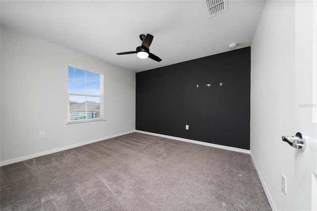 spare room with carpet floors and ceiling fan