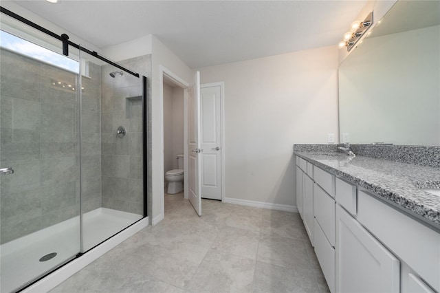 bathroom featuring toilet, vanity, and walk in shower