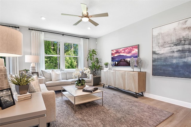 living room with hardwood / wood-style flooring and ceiling fan