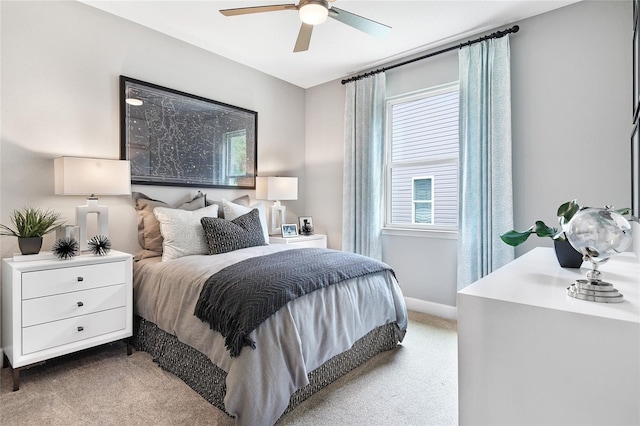 carpeted bedroom featuring ceiling fan and multiple windows