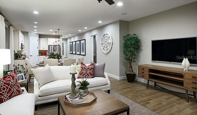 living room with ceiling fan and hardwood / wood-style floors