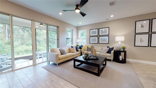 living room featuring light wood-type flooring and ceiling fan