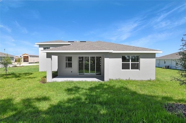 9093 Players Dr, Weeki Wachee, FL 34613 - back of property with a patio, a lawn, a shingled roof, and central AC