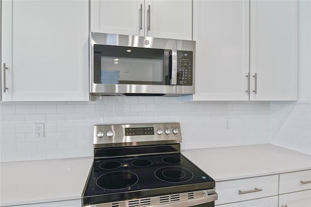 9093 Players Dr, Weeki Wachee, FL 34613 - kitchen featuring stainless steel appliances, white cabinets, and light countertops