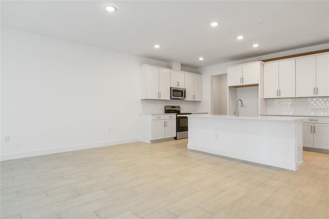 9093 Players Dr, Weeki Wachee, FL 34613 - kitchen featuring appliances with stainless steel finishes, decorative backsplash, recessed lighting, and light countertops