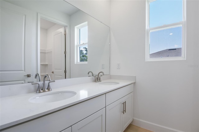 9093 Players Dr, Weeki Wachee, FL 34613 - full bathroom with double vanity and baseboards