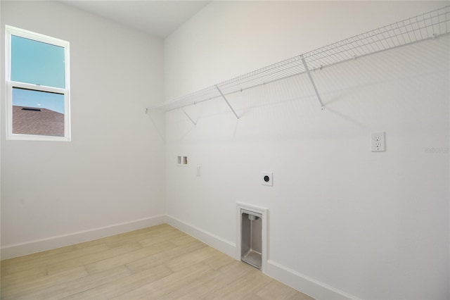 9093 Players Dr, Weeki Wachee, FL 34613 - laundry room with electric dryer hookup, light wood-type flooring, baseboards, and washer hookup