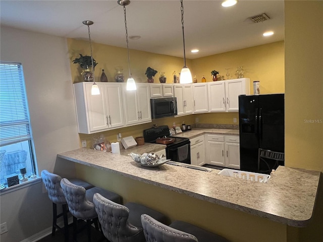 kitchen featuring hanging light fixtures, white cabinetry, kitchen peninsula, and black appliances