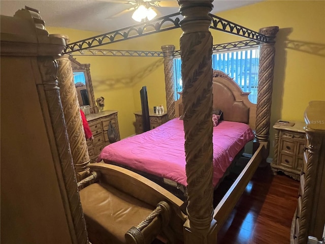 bedroom with dark hardwood / wood-style flooring and ceiling fan