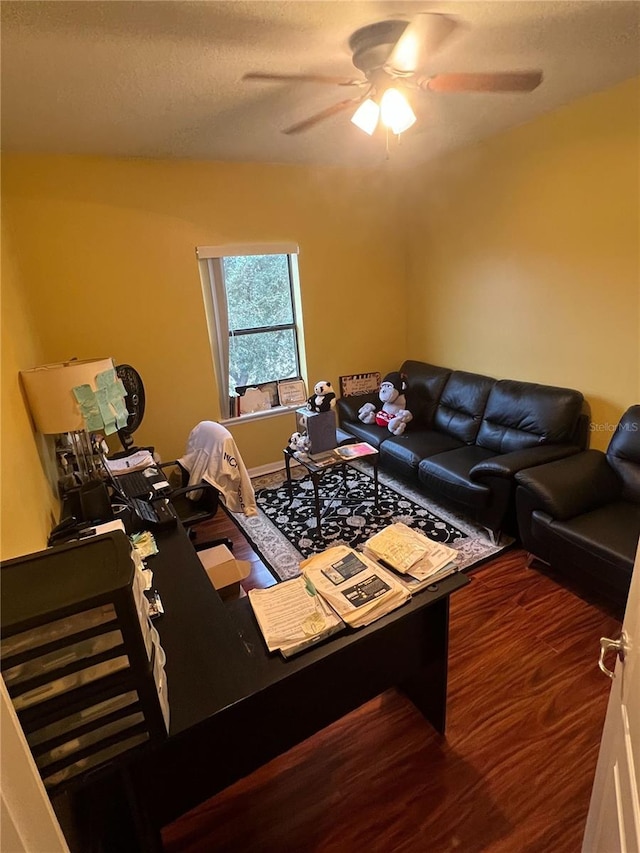 living room with hardwood / wood-style floors, a textured ceiling, and ceiling fan