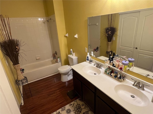 full bathroom featuring shower / tub combination, hardwood / wood-style floors, vanity, and toilet