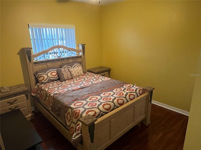 bedroom with dark wood-type flooring