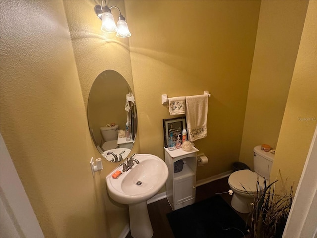 bathroom featuring toilet and sink