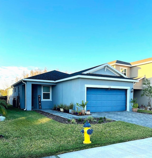 view of front of home featuring a garage and a front lawn