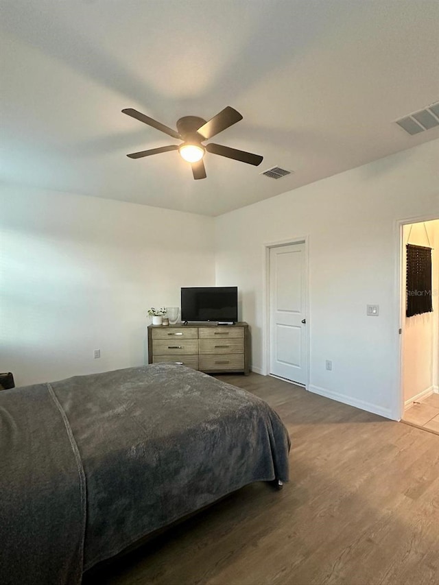 bedroom with ceiling fan and dark hardwood / wood-style flooring