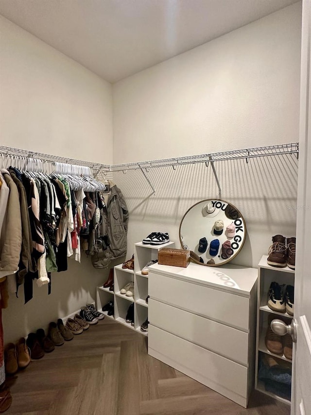 spacious closet featuring parquet flooring