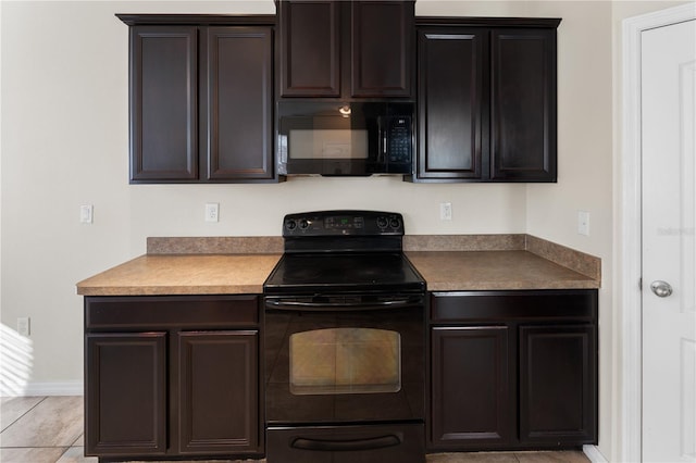 kitchen with light tile patterned floors, dark brown cabinetry, and black appliances