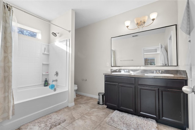 full bathroom featuring toilet, shower / tub combo with curtain, a notable chandelier, tile patterned floors, and vanity