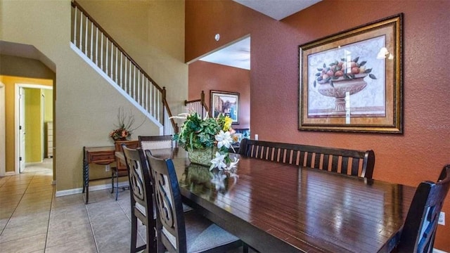 dining space featuring light tile patterned flooring