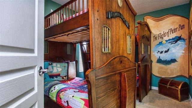 bedroom featuring a textured ceiling and carpet flooring