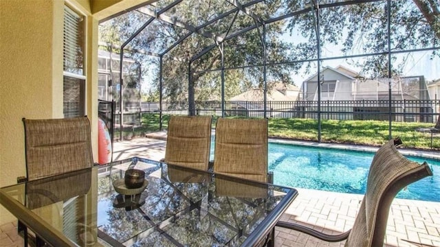 view of swimming pool featuring a lanai and a patio area