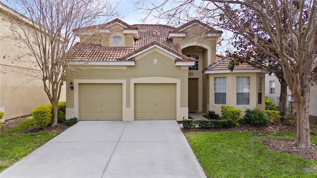 mediterranean / spanish-style home with a tile roof, driveway, an attached garage, and stucco siding