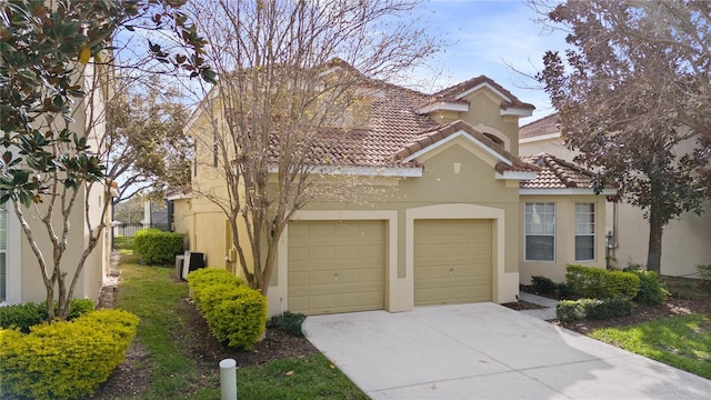 view of front of home featuring driveway, a tile roof, and stucco siding