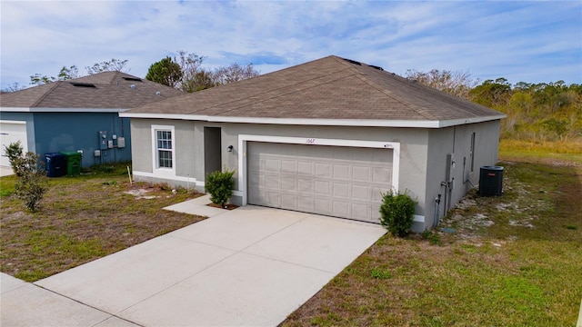 ranch-style home with a garage, a front yard, and cooling unit