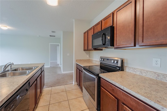 kitchen with black appliances, sink, a textured ceiling, and light tile patterned flooring