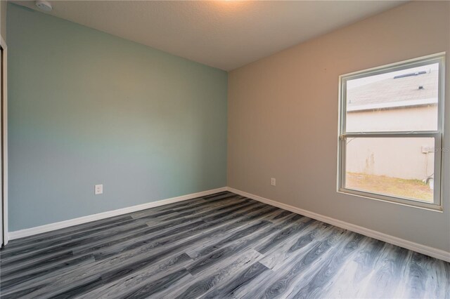 spare room with dark hardwood / wood-style flooring