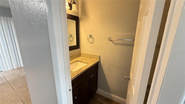 bathroom with tile patterned floors and vanity