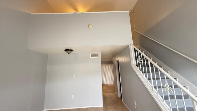 stairway featuring tile patterned floors