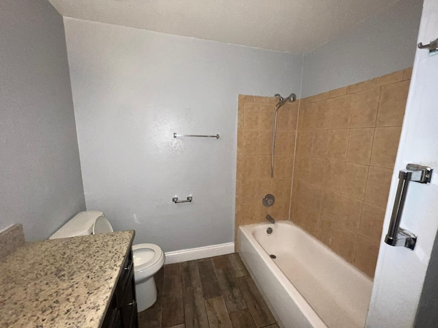 full bathroom featuring toilet, tiled shower / bath combo, and vanity