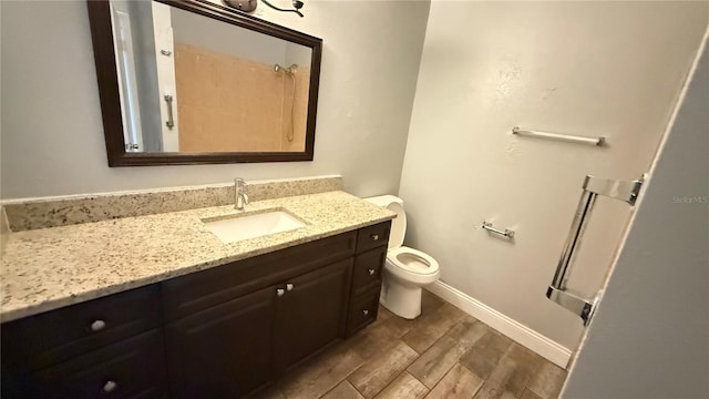 bathroom featuring toilet and vanity