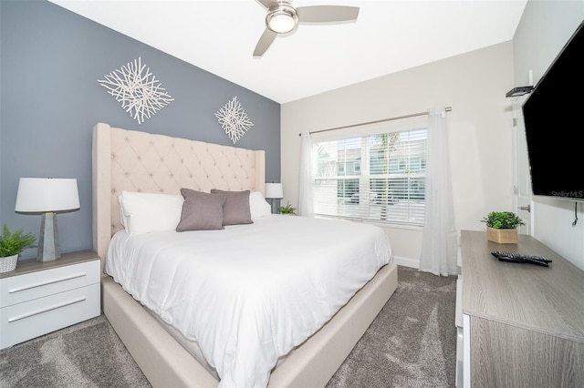 bedroom with ceiling fan and dark carpet