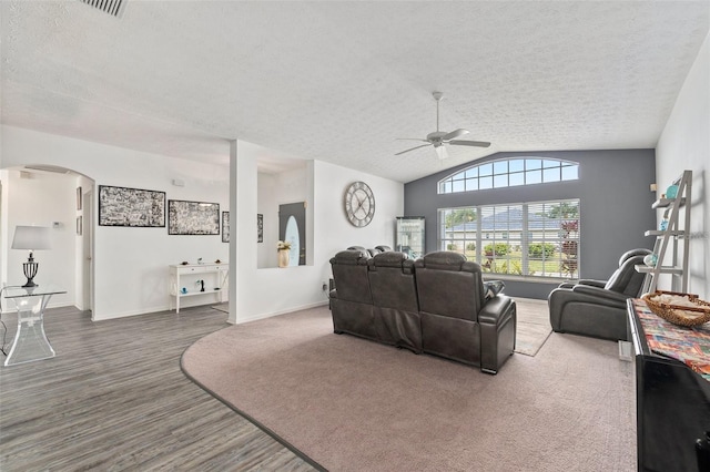 living room with lofted ceiling, ceiling fan, and a textured ceiling