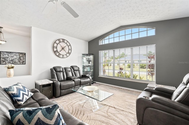 living room featuring a textured ceiling, ceiling fan, and vaulted ceiling