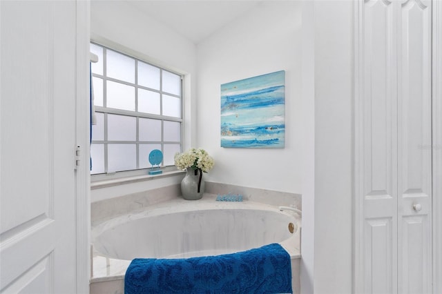 bathroom featuring a tub to relax in