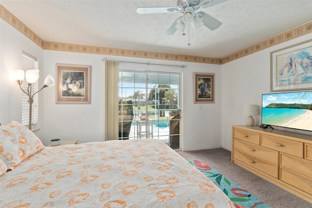 carpeted bedroom with ceiling fan, access to exterior, and a textured ceiling