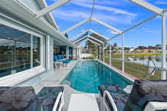 view of pool featuring glass enclosure, a water view, and a patio