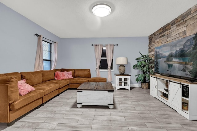 living room with a textured ceiling and light hardwood / wood-style flooring