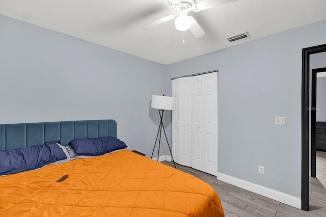 bedroom featuring a closet, ceiling fan, and hardwood / wood-style floors