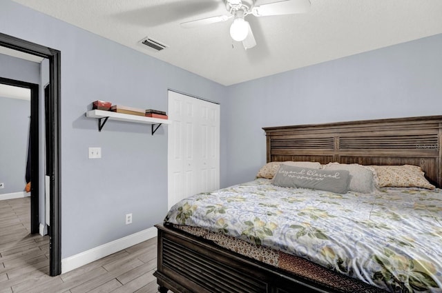 bedroom featuring a closet, ceiling fan, and light hardwood / wood-style flooring