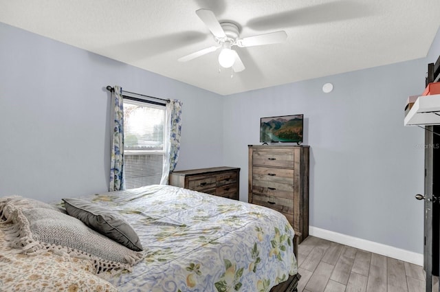 bedroom with light wood-type flooring and ceiling fan