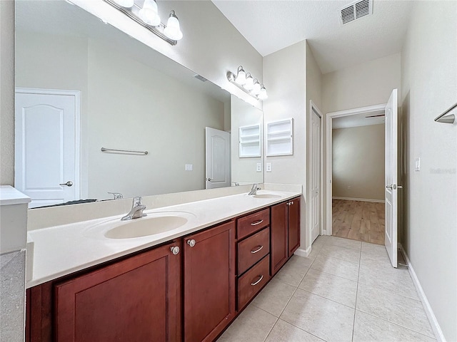 full bathroom featuring tile patterned floors, visible vents, a sink, and double vanity