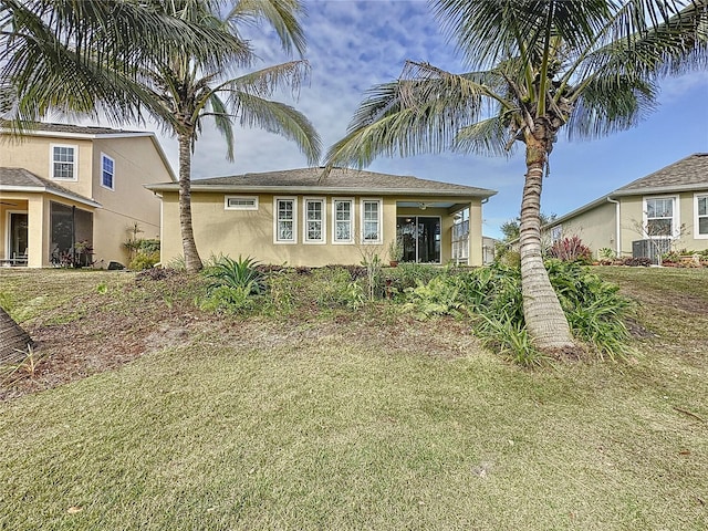 view of front of home featuring a front lawn and stucco siding