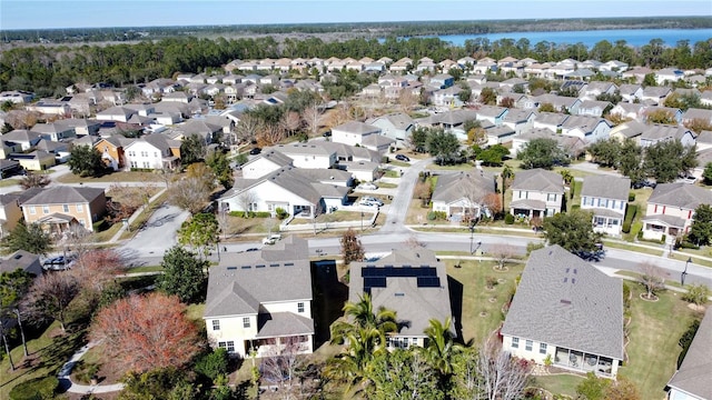 bird's eye view featuring a residential view and a water view